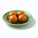 Royal Gulabjam sweet balls in syrup on green plate
