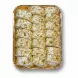 Tray of sliced pistachio cream rolls topped with chopped pistachios
