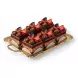 Tray of multiple rich chocolate berry cake slices decorated with fresh fruits and chocolate