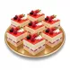 Multiple slices of strawberry berry layer cake beautifully arranged on a golden tray