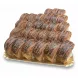 Tray of freshly made chocolate swirl cake rolls with chocolate drizzle and shavings