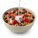 Bowl of Alpen muesli with fresh berries and milk