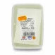 Close-up of feta cheese in brine with product label showing weight and barcode