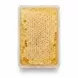 Transparent container showing natural honeycomb with golden honey