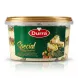Enhanced Hand holding a tub of Durra Special Halawa Pistachios in a shop