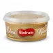A side view of a Bodrum brand round tub containing Plain Tahini Halva, set against a clean white background. The product fills most of the frame, with professional studio lighting and soft, equal shadows on both sides.