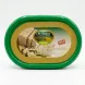 A 1:1 professional e-commerce product photograph features a centered green plastic tub of Al Dayaa Halawa with Pistachios. The shimmering gold and white label displays the product brand, title in English and Arabic, and a "MADE IN LEBANON" stamp. All background elements, imperfections, and external tags have been removed. The product fills 85% of the frame, is in sharp focus, and is illuminated by professional studio lighting with a soft, even shadow.