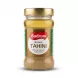 Enhanced Hand holding a jar of Bodrum Brown Tahini with front label visible