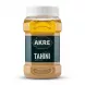 A 1700g plastic jar of AKRE Tahini, an authentic sesame spread, featuring its green and blue label, with a ribbed white cap, displayed on a clean white background with a soft, even shadow.