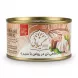 Enhanced Hand holding Gilani Tuna Fish in Oil with Garlic 180g tin in a grocery aisle
