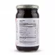 A 1:1 professional e-commerce product photograph featuring a centered, glass jar of Ahmed Rose Petal Spread, clearly displaying the bilingual (English and Arabic) Nutrition Facts label against a clean, white, studio background with a soft, symmetrical shadow. PRODUCT TITLE: Ahmed Rose Petal Spread PRODUCT: Nutrition facts label of Ahmed Rose Petal Spread jar PREFERENCES: - Aspect ratio: 1:1 A perfectly centered, high-resolution, professional e-commerce studio photograph of a single glass jar of Ahmed Rose Petal Spread, presented on a flawless white background. The jar, which appears full of dark, rose-petal preserve, is isolated and fills approximately 85% of the 1:1 frame. All background elements from the original supermarket setting, including the person’s hand, watch, clothing, and shelving, are completely removed. The jar is positioned with the complex "Nutrition Facts" label (as seen in image_0.png) facing directly forward and in sharp, legible focus. This label details, in both English and Arabic, specific information like "Serving size 2 tbsp (40g)," "Calories 120," "Total Fat 0g," "Total Carbohydrate 30g," "Protein 0g," and "Sodium 0mg," along with the percent Daily Value. The label's appearance, including all specific text and formatting, is meticulously preserved and cleaned of all imperfections. The text is crisp and easily readable. The glass jar itself is pristine and free of dust, fingerprints, or labels on other surfaces (the small remnants at the bottom edge of the label have been cleaned up). The patterned foil cap at the top is clean and sharp. The entire jar is uniformly and professionally lit with a soft-box studio lighting setup, eliminating harsh shadows and reflections. A subtle, soft, symmetrical shadow is present beneath the base of the jar, grounding it and keeping equal visual weight on both sides. The product appears tactile and clean, with the texture of the spread inside visible through the clear glass areas. The overall image is balanced and high-quality, typical of a top-tier online retailer listing.