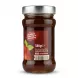 A clear glass jar filled with Bodrum Rosehip Jam is centered, showing the back label. The label states 'no added colouring or flavouring', '380g e', the website 'bodrumfoods.co.uk', social media handles, and a barcode. The product is against a plain white background with professional studio lighting and a soft, even shadow.