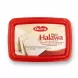 Enhanced Durra Plain Halawa 700g tub held in hand in front of grocery shelves