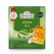 A 1:1 professional e-commerce product photograph of the Ahmad Tea Green Tea Classic Blend box, featuring 100 tagged bags and a 'FREE SPOON' promotion badge with an attached tea spoon. The green package displays the 'The King's Awards for Enterprise' and 'Great Taste 2023' awards against a clean white background with soft, even studio lighting.