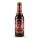 A 320ml glass bottle of Istak Pomegranate Non Alcoholic Malt Beverage is centered on a clean white background. It features a maroon and gold label with images of fresh pomegranates and the product name in large English and Arabic text.