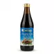 Enhanced Cortas Tamarind Syrup 600ml bottle with gold cap, held in hand in a grocery store aisle