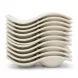 A stacked set of eight distinctive S-shaped, cream-colored ceramic saucers from a coffee set, shown isolated against a pure white background. The stacked saucers form a continuous wavy profile, highlighting their unique curved design.
