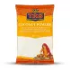 A 1kg plastic bag of TRS brand fine white Coconut Powder. The package has an orange top border with the brand logo and the product name "Coconut Powder" listed in multiple languages. Below, a clear window shows the product, alongside an illustration of a woman in traditional clothing processing coconuts. The bag is centered on a plain white background with professional studio lighting and soft, symmetrical shadows.