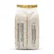 A centered, professional 1:1 square studio photograph of the back of a large plastic packet of Orouba Roasted Pumpkin Seeds. The white packaging features two clear vertical columns of Arabic text detailing product information and contact details, set against a seamless solid white background with soft studio lighting.