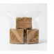 Three blocks of traditional raw African black soap in a clear plastic bag with a £5.00 label