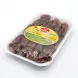 Hand holding a tray of Sofra Tunisian Dates 400g in a grocery store aisle