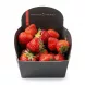 A hand holding a carton of fresh Beekers Berries strawberries.