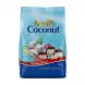 Mell's Coconut Sweets pack held in hand, shop display in background